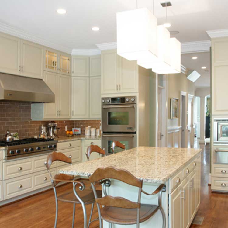 A Modern Kitchen With White Cabinets And Counter Tops With Stainless Steel Appliances