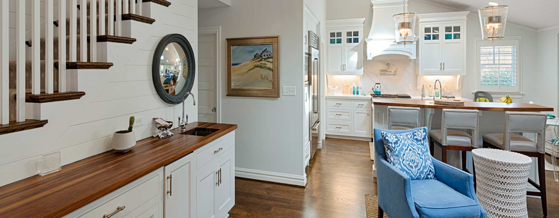 A kitchen remodel with white cabinets and hardwood floors built by Covington Contracting luxury custom homebuilder in Hampton Roads Virginia