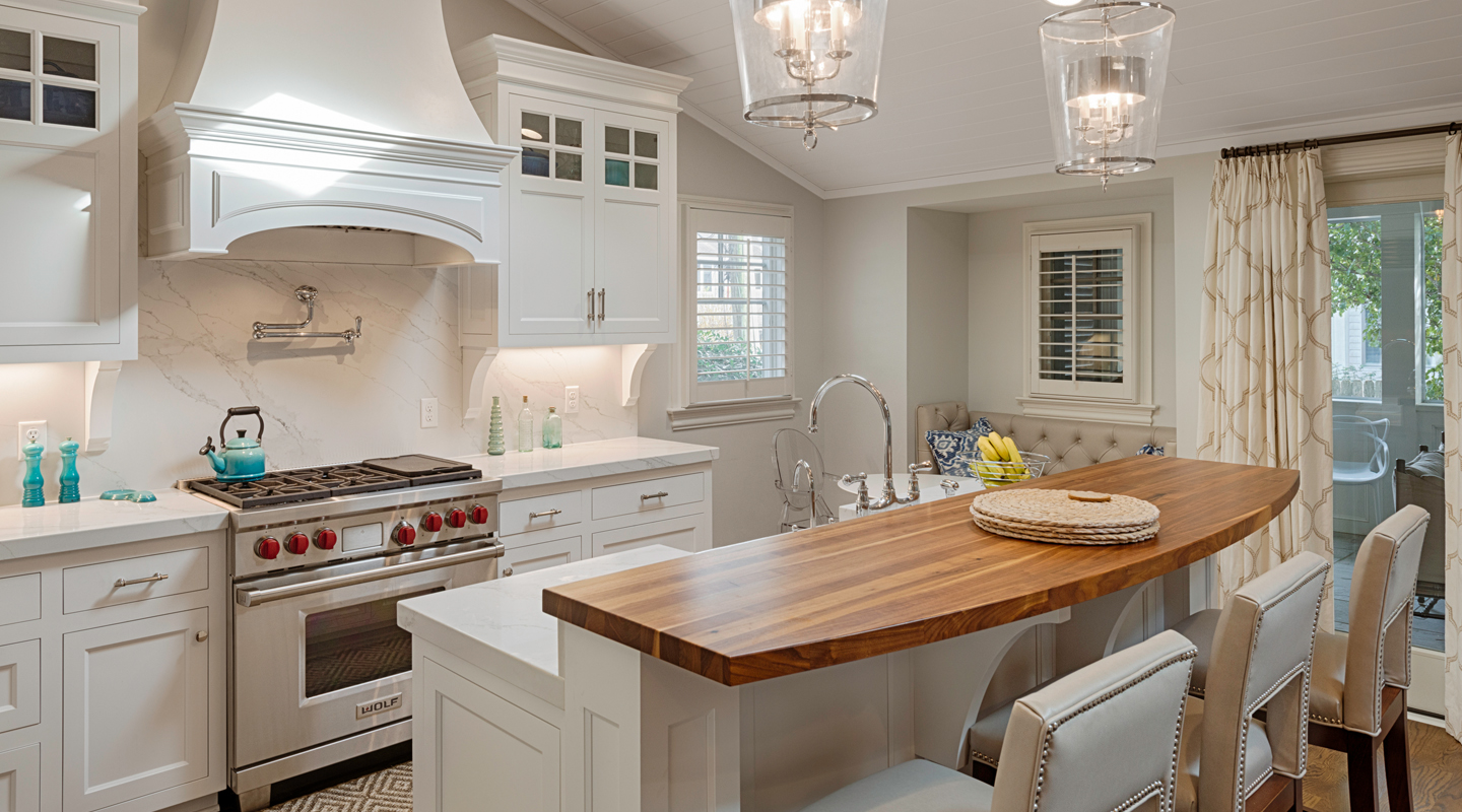 A beautiful white kitchen with a wood and stone counter top showing a remodeling job by Covington Contracting